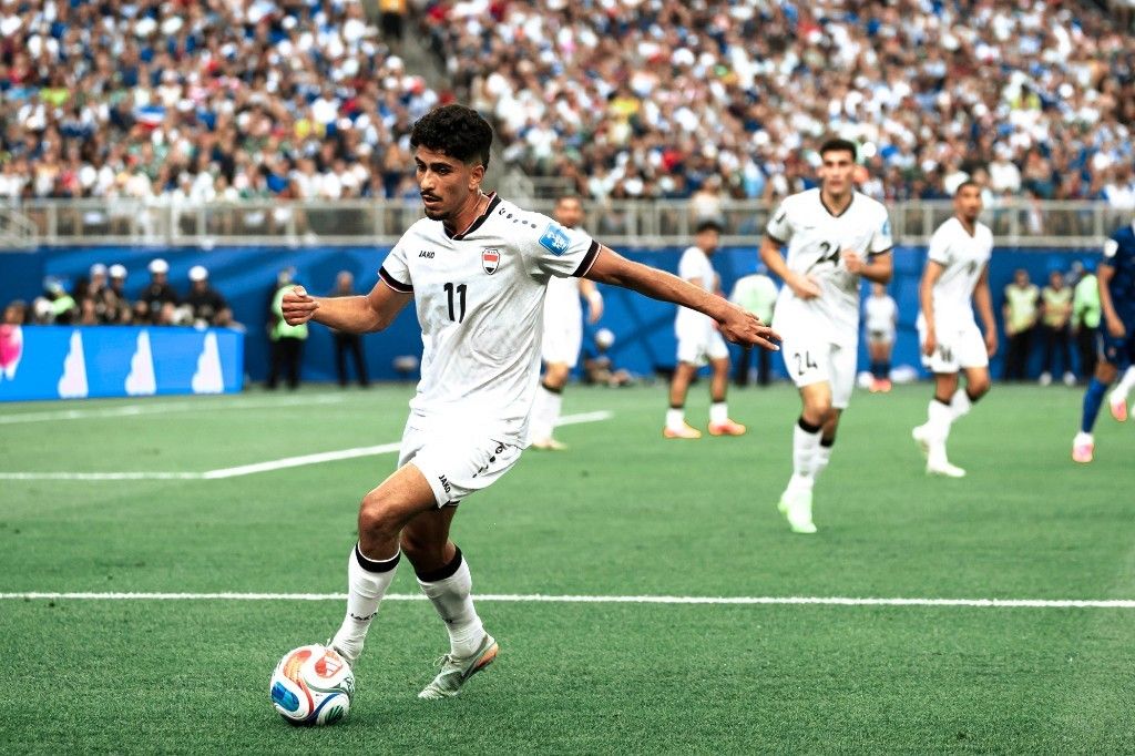 Iraq's number 11 dribbles under pressure during the World Cup group-stage match against France