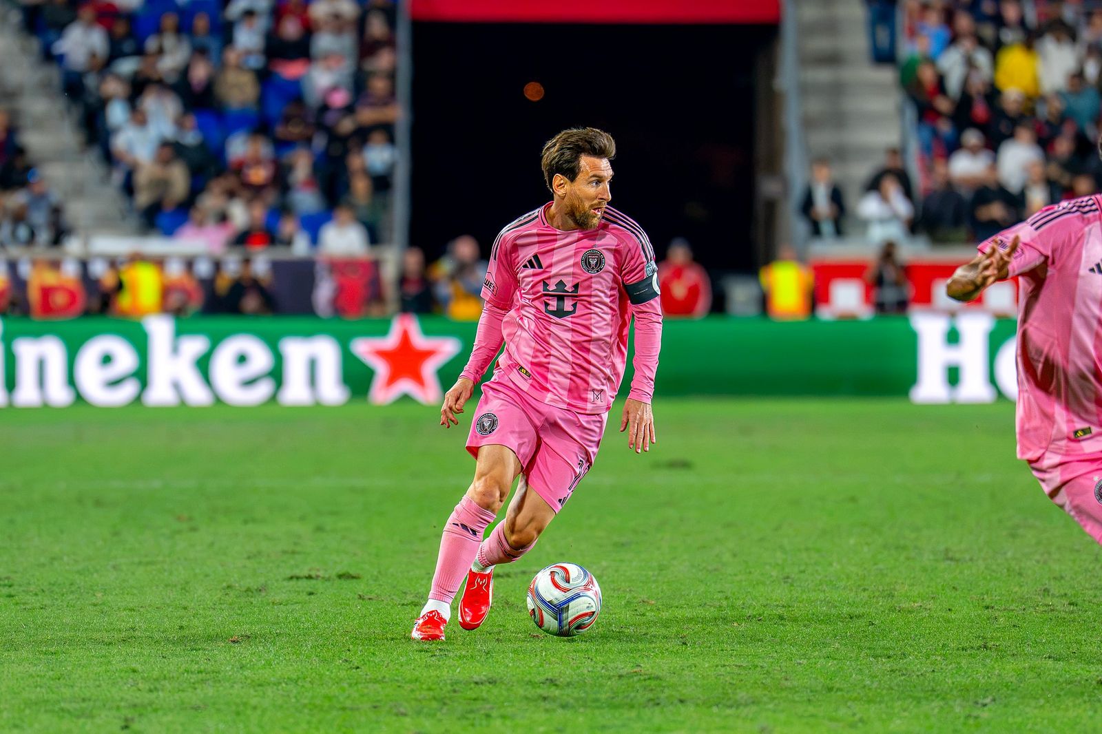 An Inter Miami player in pink dribbles the ball during the match against Red Bull New York at Sports Illustrated Stadium on October 24, 2026.