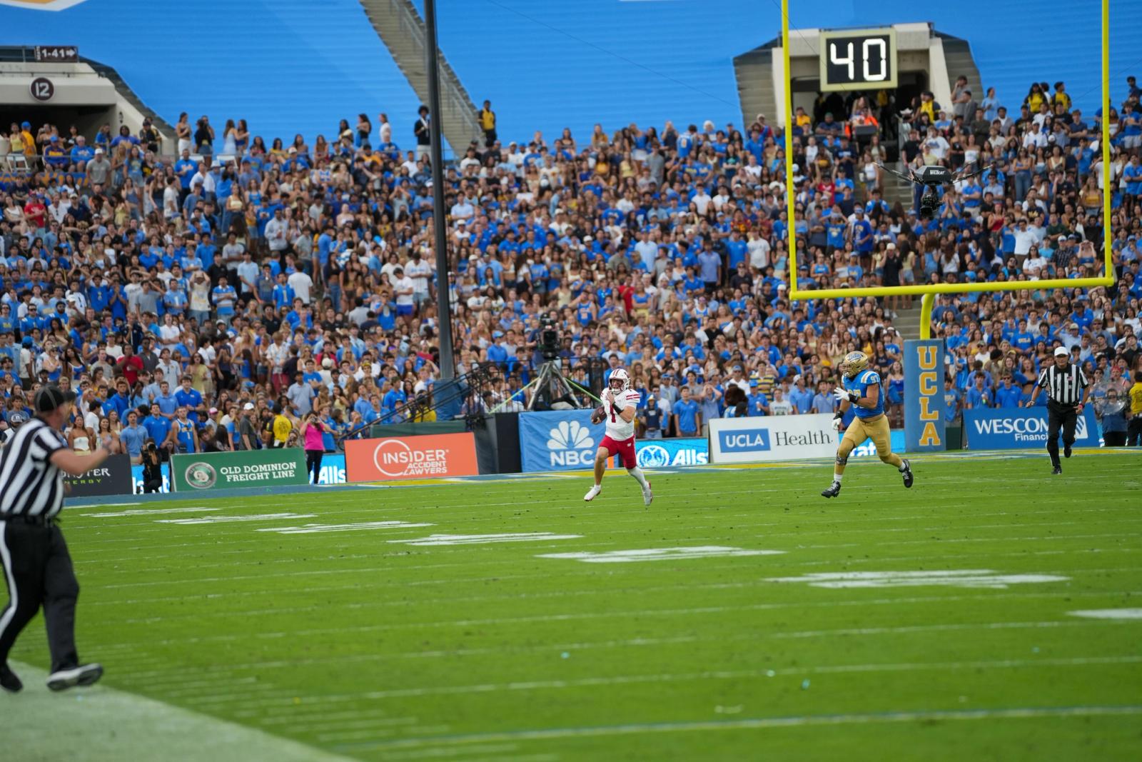 UCLA and Wisconsin players in the end zone in front of the Rose Bowl crowd