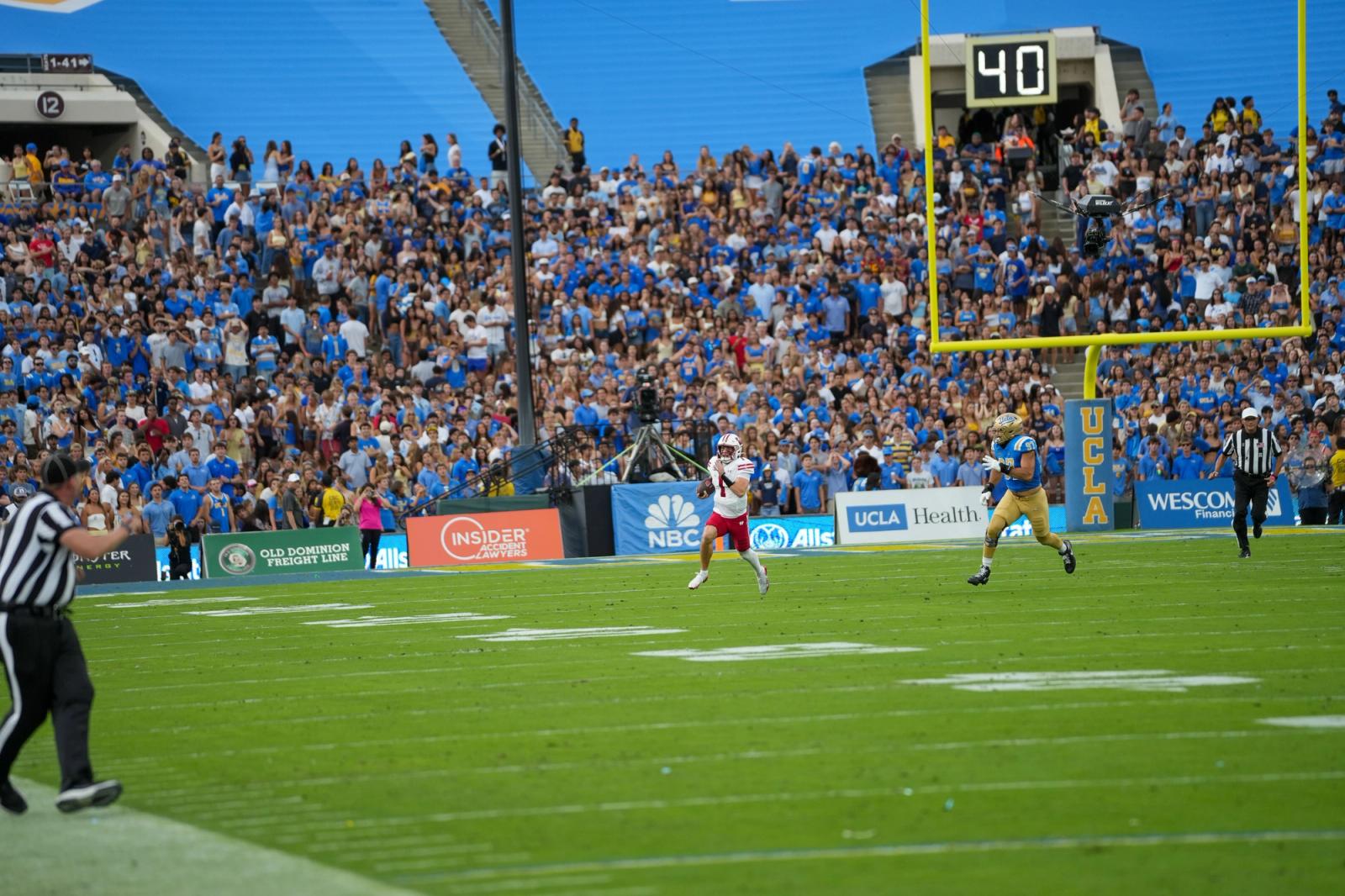 UCLA and Wisconsin players in the end zone in front of the Rose Bowl crowd