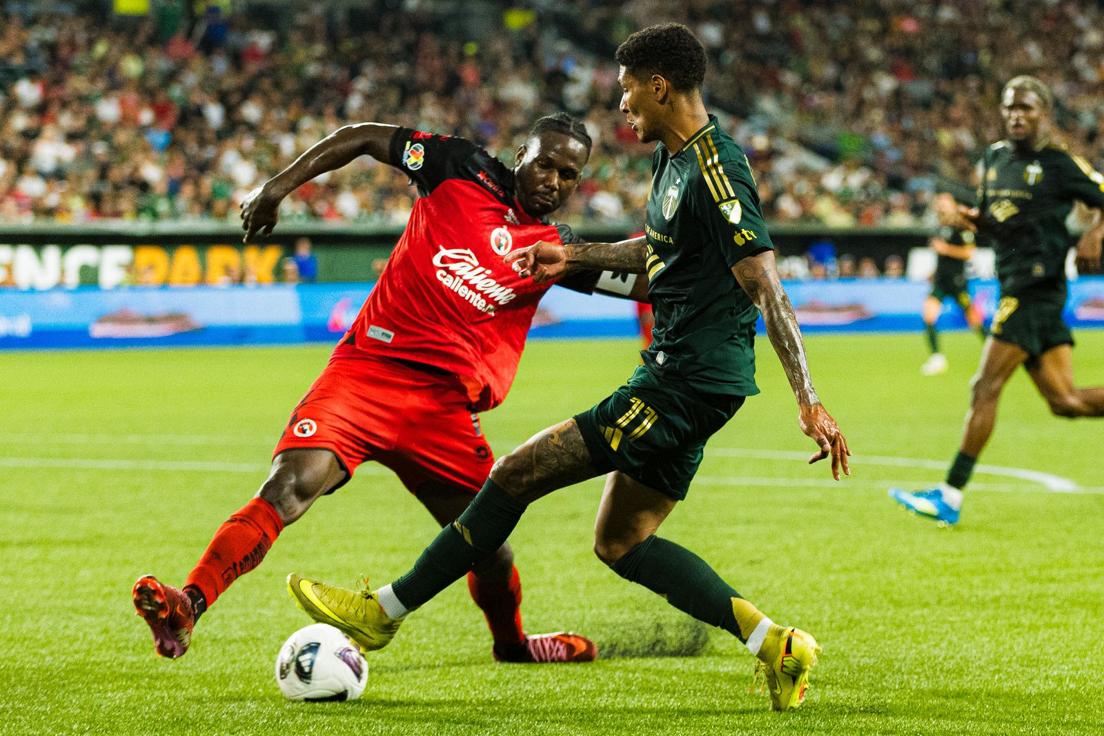 Portland Timbers winger Antony battles a Club Tijuana defender for the ball during the August 13, 2026 Leagues Cup match at Providence Park.