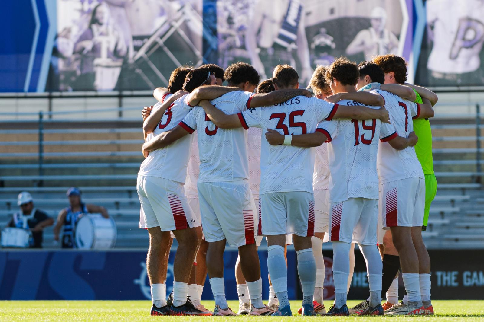 Portland Pilots huddle on the pitch at Merlo Field — Photo Credit: Aaron Leopold/Undrafted