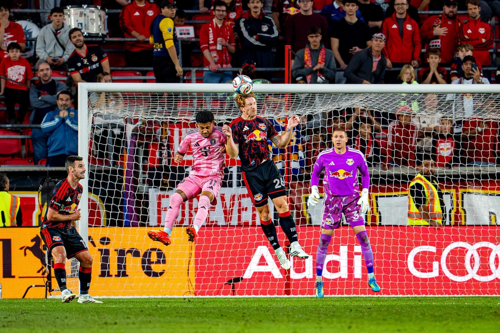 Players leap for a high ball in front of goal as the goalkeeper watches during Red Bull New York vs. Inter Miami at Sports Illustrated Stadium on October 24, 2026.