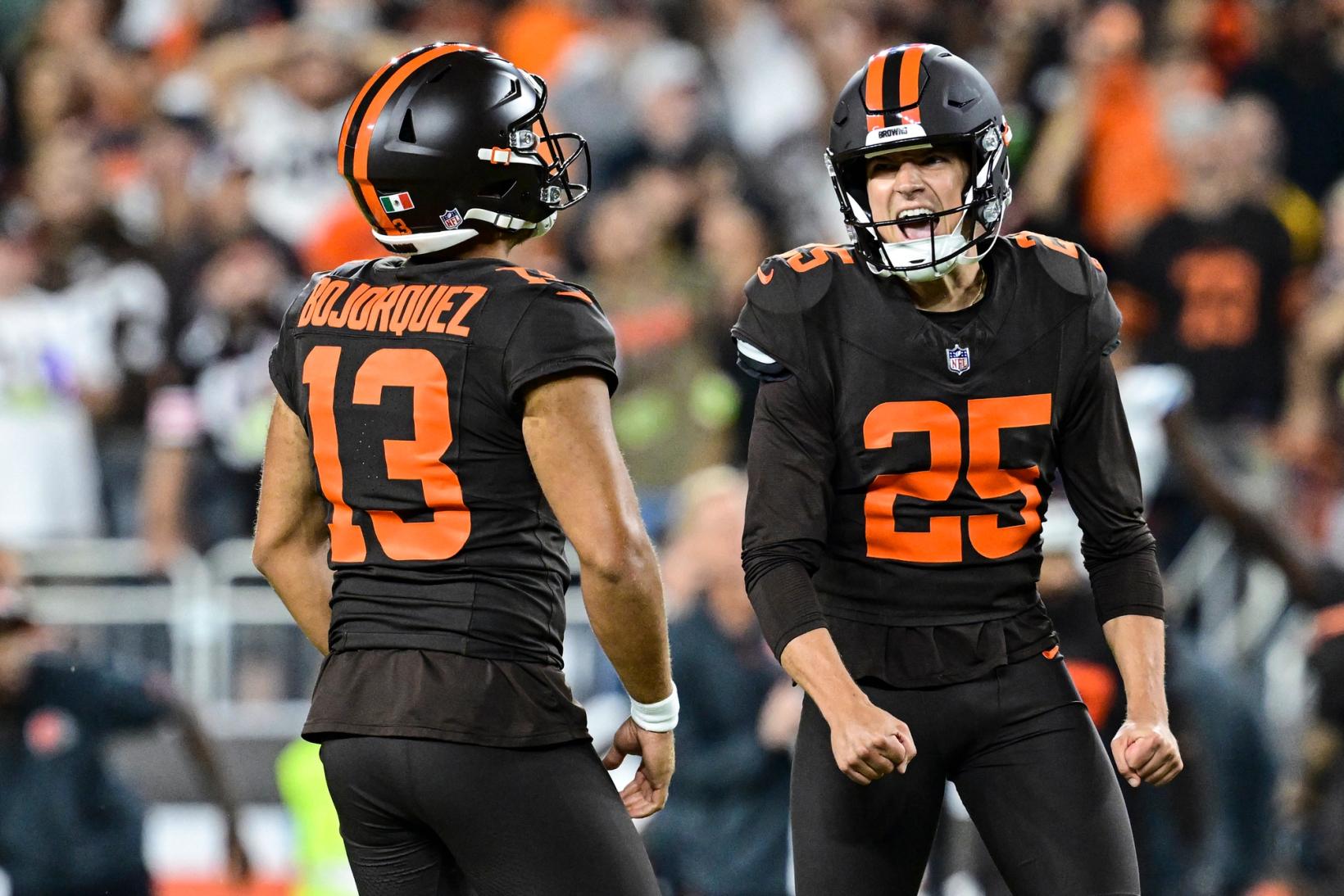 Cleveland Browns kicker Andre Szmyt (25) yells with both fists clenched beside punter Corey Bojorquez (13) during the Browns' game against the Pittsburgh Steelers.
