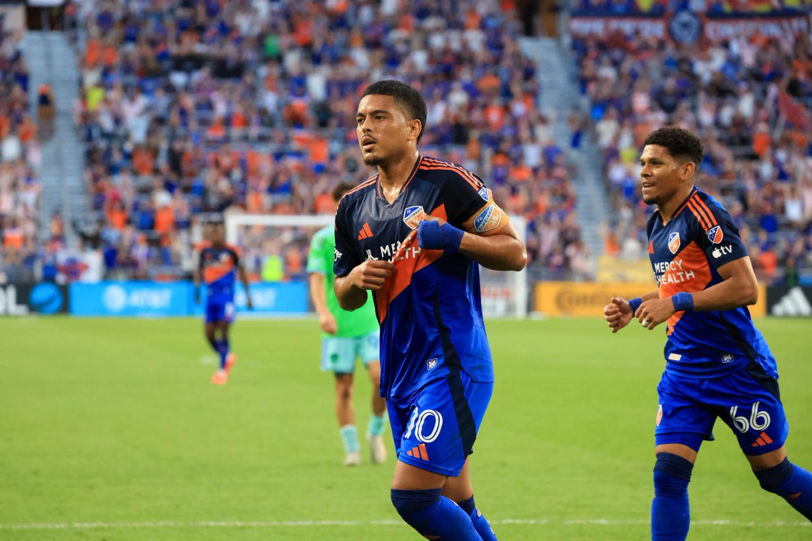 FC Cincinnati midfielder Evander celebrates with a teammate after scoring against the Seattle Sounders during the August 22, 2026 match at TQL Stadium.