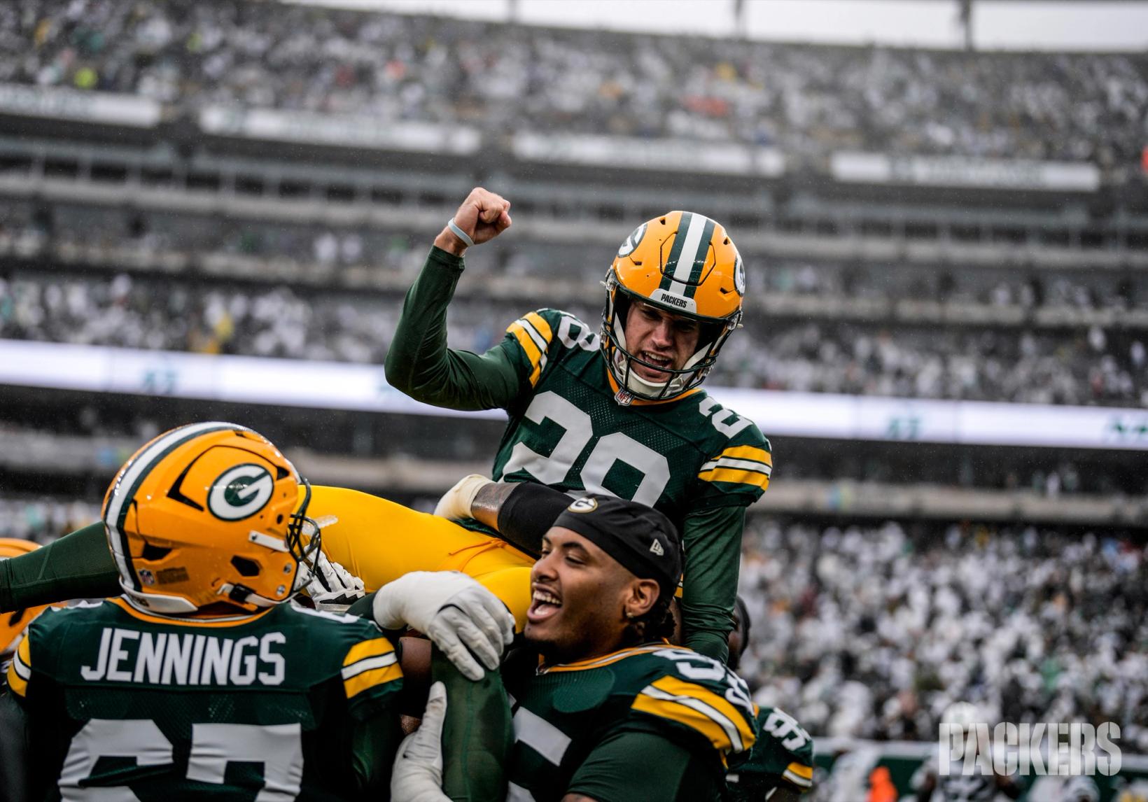 Green Bay Packers kicker Trey Smack (28) pumps his fist as teammates lift him onto their shoulders at MetLife Stadium