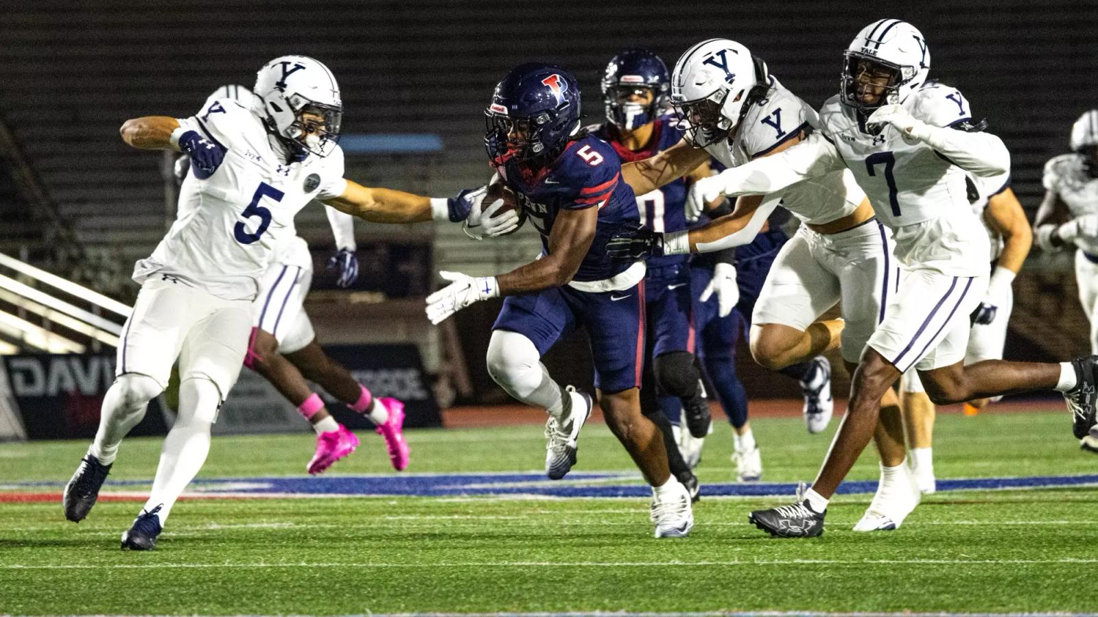 Penn running back Sean Williams (5) carries the ball through Yale defenders at Franklin Field during Penn's 24-21 win over Yale on Oct. 23, 2026