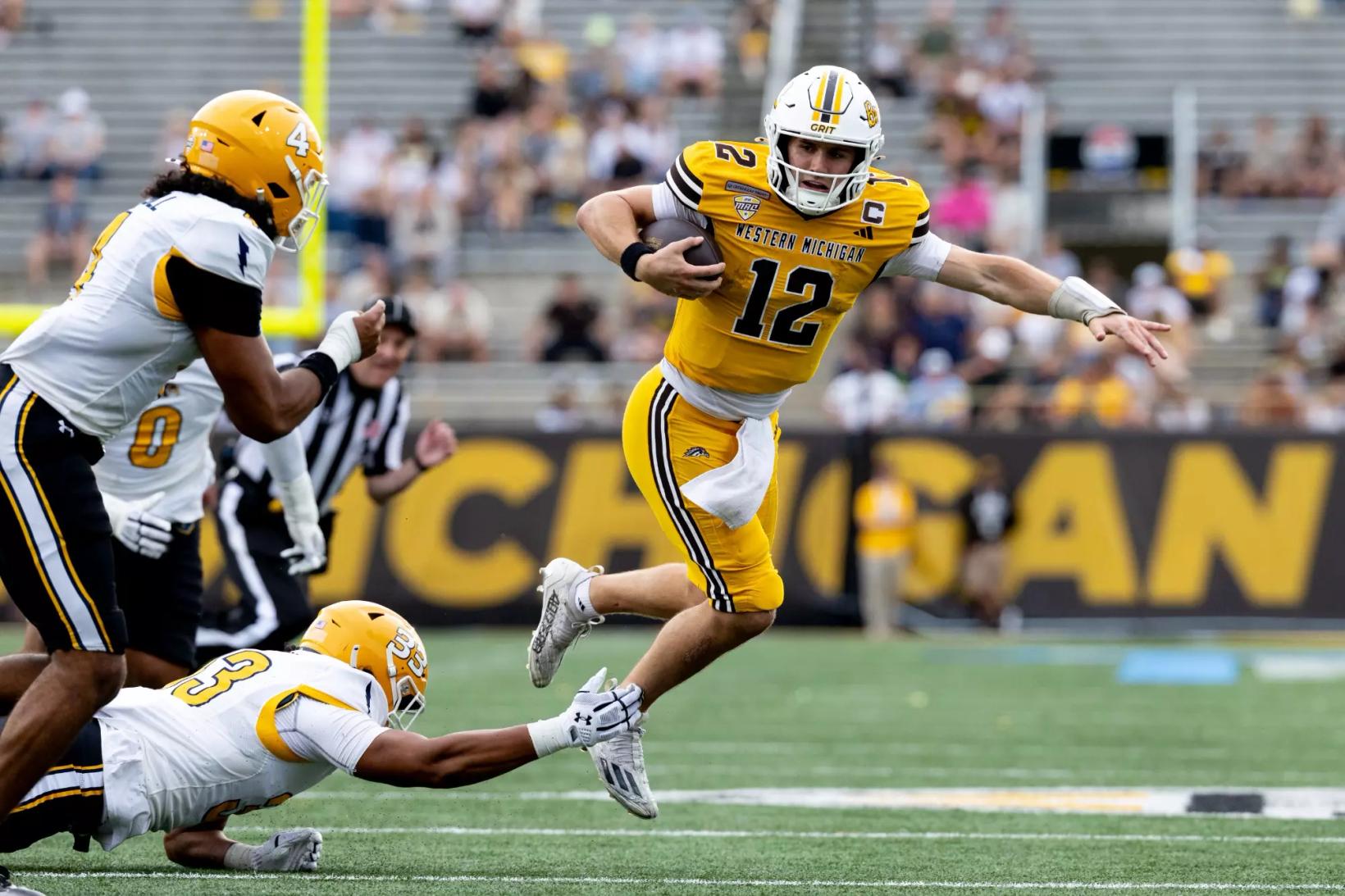 Western Michigan quarterback Broc Lowry runs past a Kent State tackler during the Broncos' homecoming win at Waldo Stadium on Oct. 10, 2026 (file photo)
