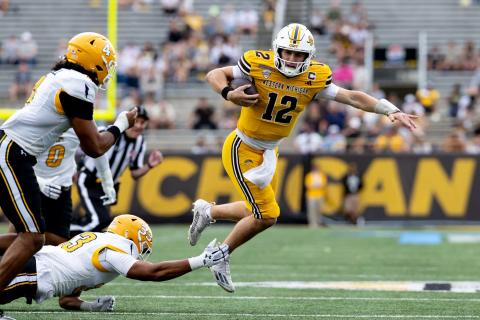 Western Michigan quarterback Broc Lowry runs past a Kent State tackler during the Broncos' homecoming win at Waldo Stadium on Oct. 10, 2026 (file photo)