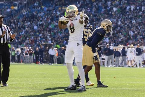 A Notre Dame player in a white No. 8 jersey points after a play as Navy defenders look on during Notre Dame's 35-13 win over Navy at Gillette Stadium in Foxborough, Mass., on Oct. 31, 2026.