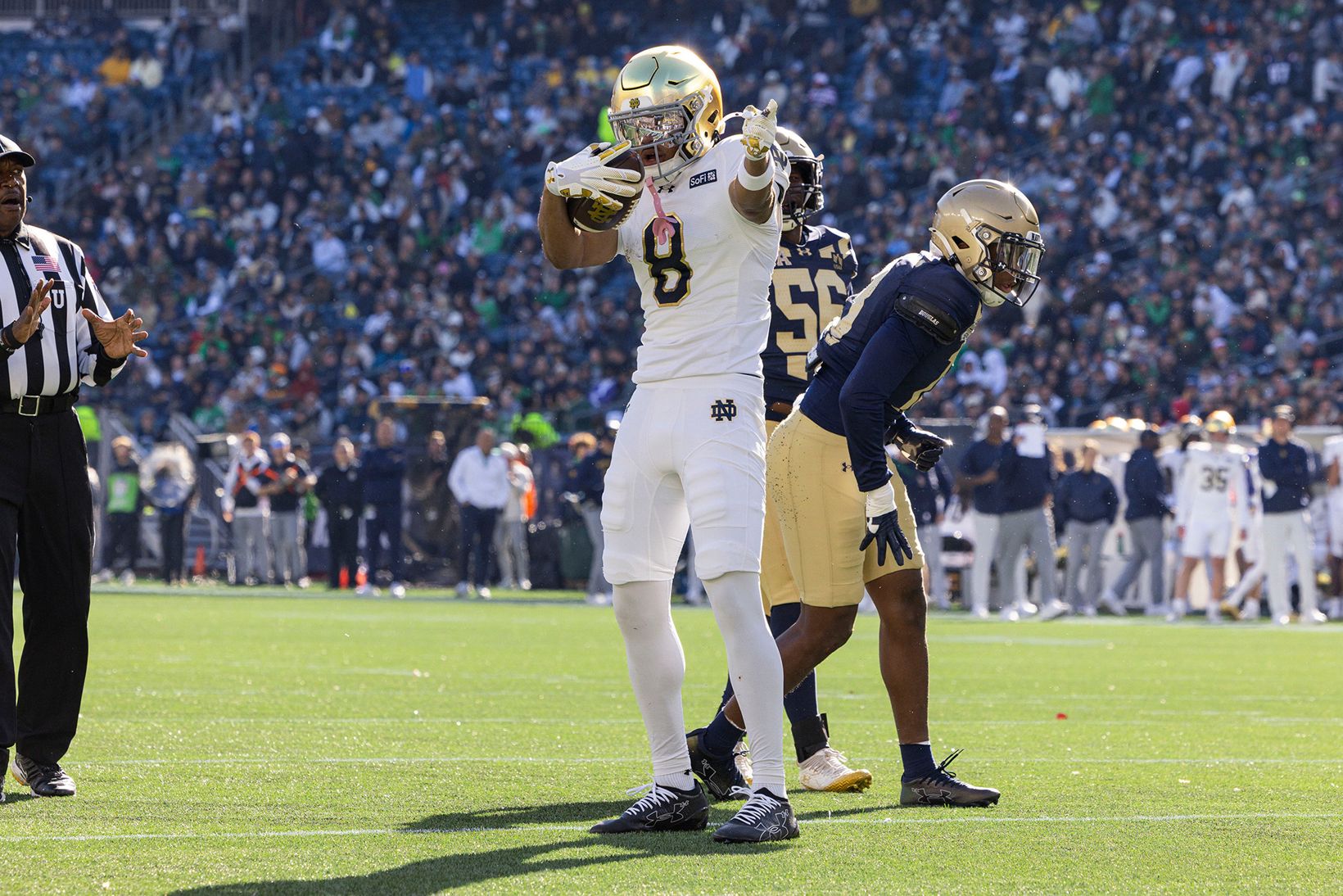 A Notre Dame player in a white No. 8 jersey points after a play as Navy defenders look on during Notre Dame's 35-13 win over Navy at Gillette Stadium in Foxborough, Mass., on Oct. 31, 2026.