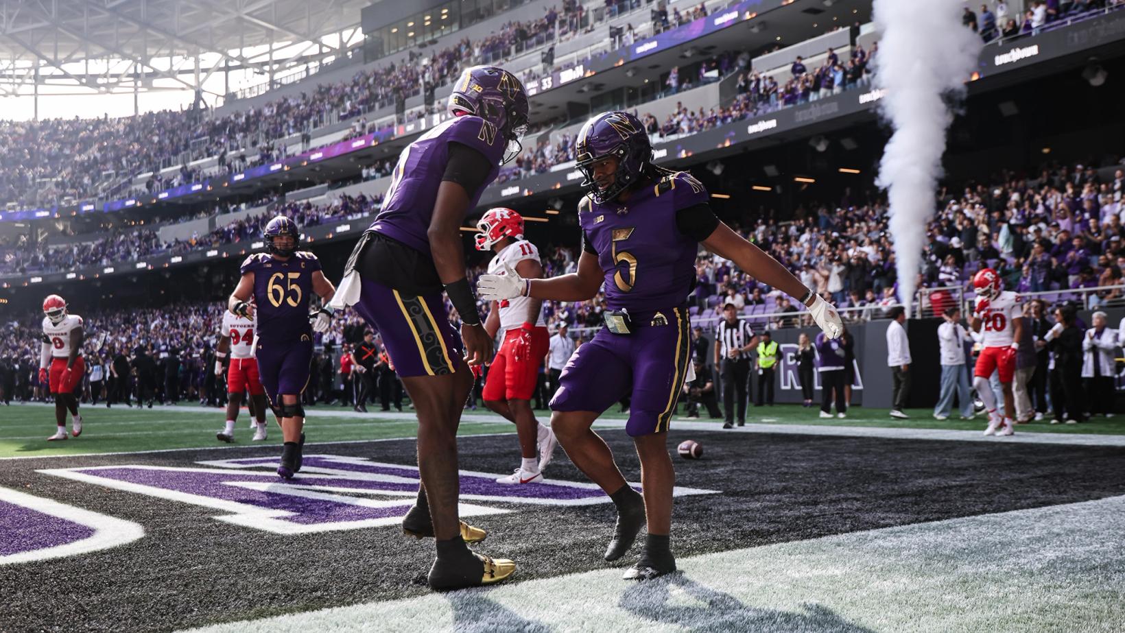 Northwestern running back Caleb Komolafe (5) celebrates with a teammate in the end zone as Rutgers players look on during Northwestern's 42-14 win at Ryan Field on Oct. 24, 2026