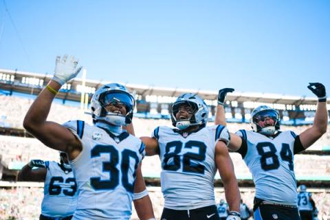 Carolina Panthers running back Chuba Hubbard (30), tight end Tommy Tremble (82) and a teammate raise their arms in celebration during the game against the Philadelphia Eagles at Lincoln Financial Field.
