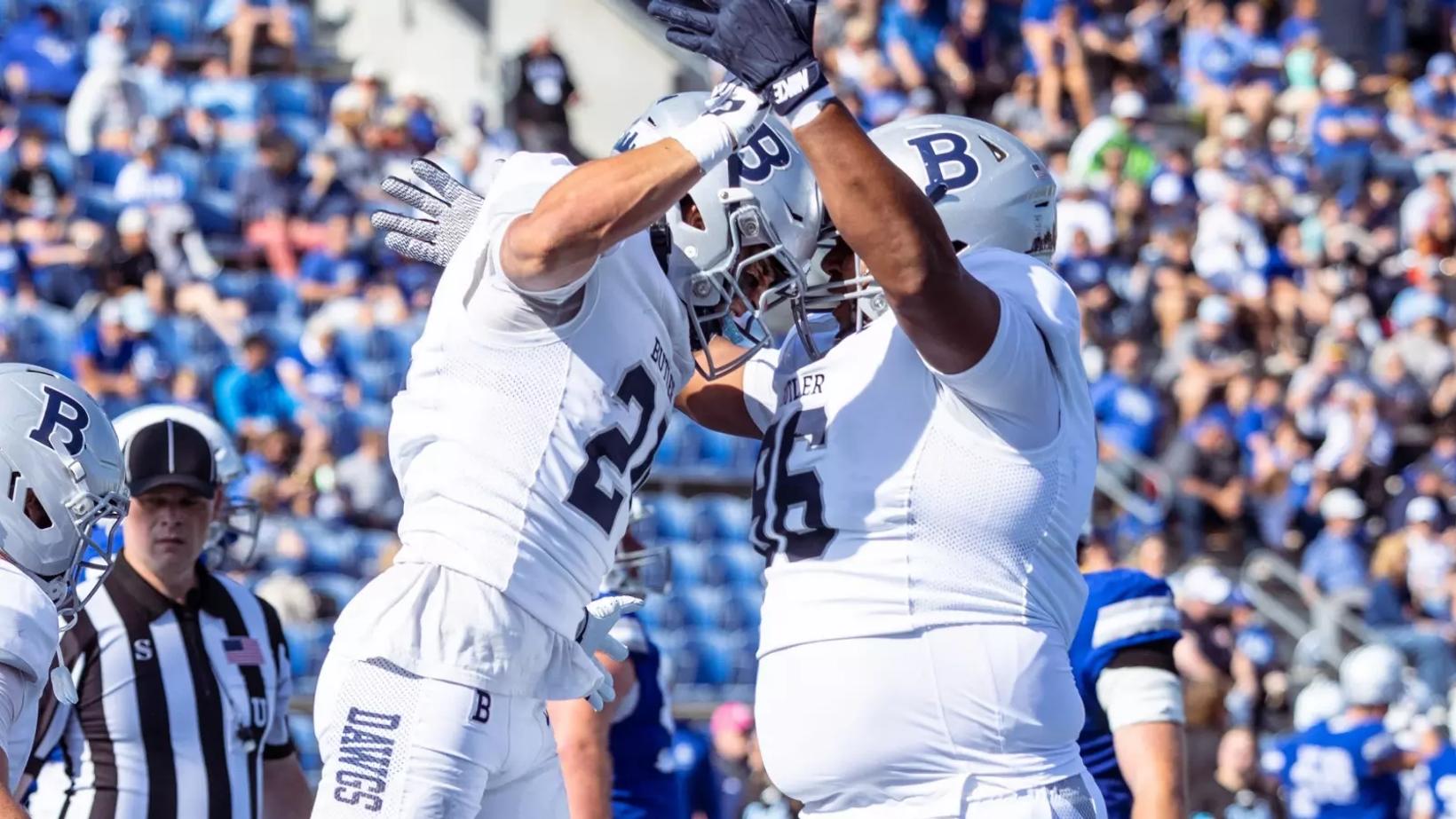 Butler players in white celebrate in the end zone during the Bulldogs' 33-21 win over Drake at Drake Stadium in Des Moines on October 24, 2026.