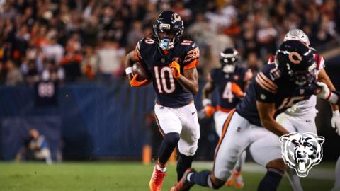 Chicago Bears wide receiver Luther Burden III (10) runs with the ball as wide receiver Rome Odunze (15) blocks a New England Patriots defender and running back D'Andre Swift (4) trails the play during a night game.