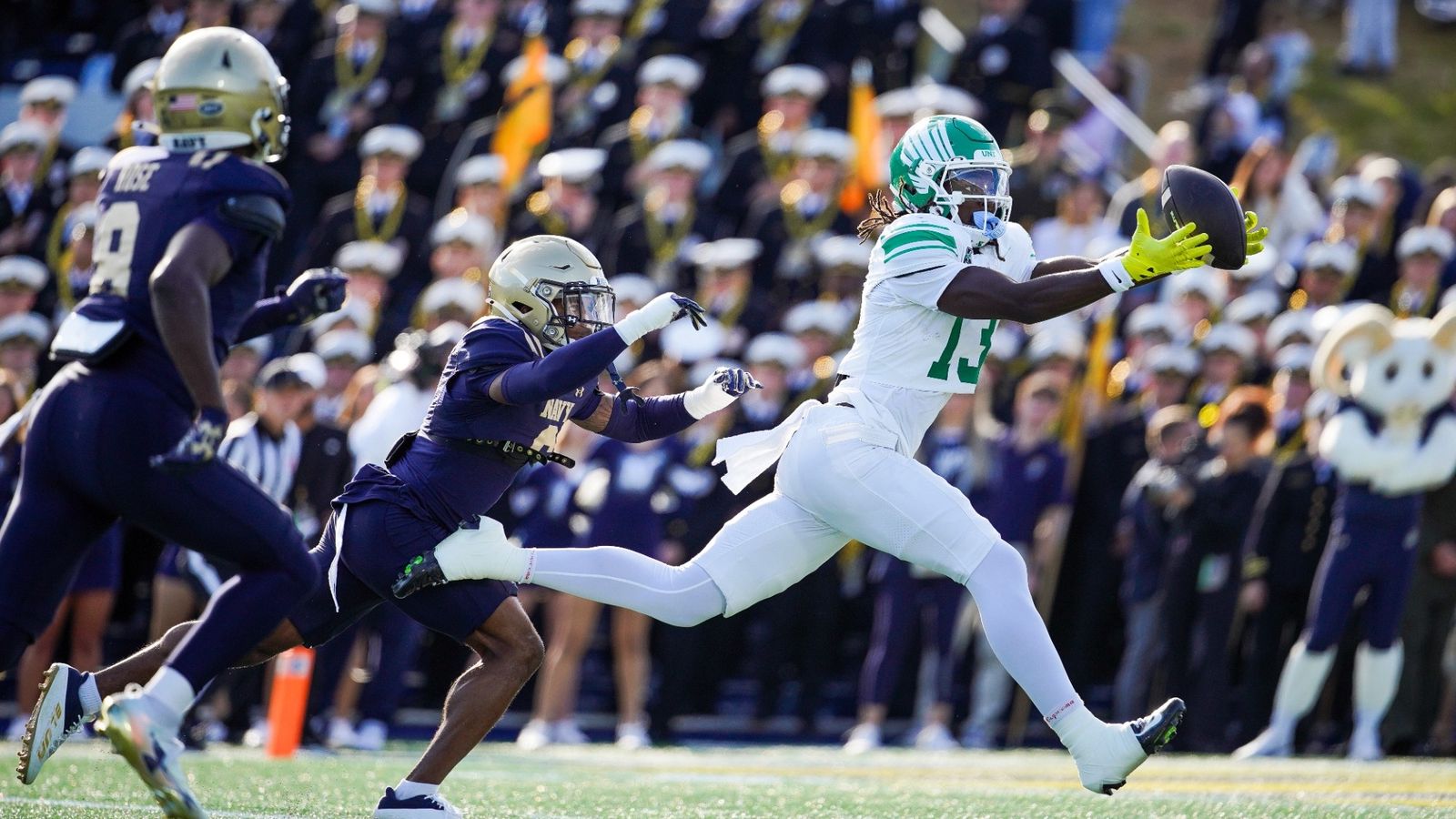 North Texas receiver Justin Stevenson, in white, stretches out for a catch ahead of a Navy defender at Navy-Marine Corps Memorial Stadium on October 24, 2026.