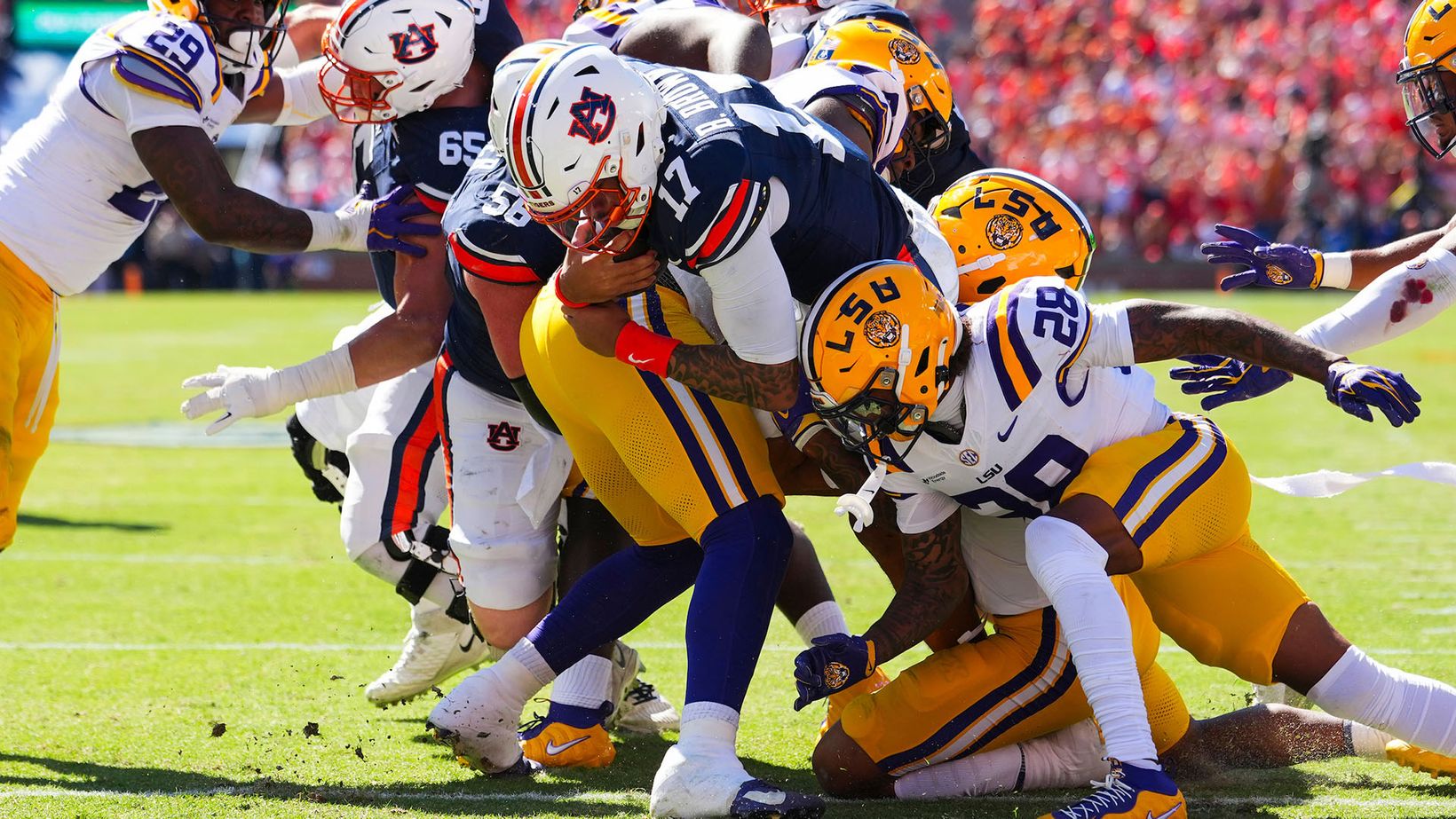 Auburn quarterback Byrum Brown (17) drives forward at the goal line as LSU defenders wrap him up during LSU's 38-17 win at Jordan-Hare Stadium on Oct. 24, 2026