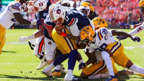 Auburn quarterback Byrum Brown (17) drives forward at the goal line as LSU defenders wrap him up during LSU's 38-17 win at Jordan-Hare Stadium on Oct. 24, 2026