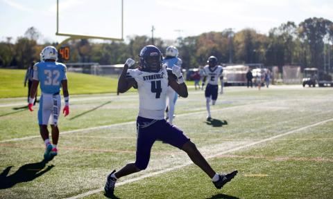 Stonehill receiver Jaylin Baker, wearing No. 4 in a white jersey, celebrates on the field at LIU as an LIU defender in light blue walks away on Oct. 24, 2026