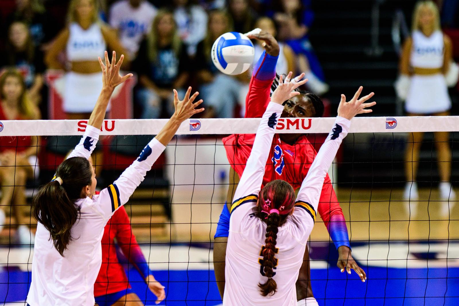 Photo Credit: Luis Revilla Mata/Undrafted — SMU #21 spikes at the net against a Cal double block