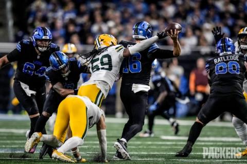 Detroit Lions quarterback Jared Goff (16) throws a pass as Green Bay Packers linebacker Ty'Ron Hopper (59) reaches for him and Lions offensive linemen block at Ford Field.