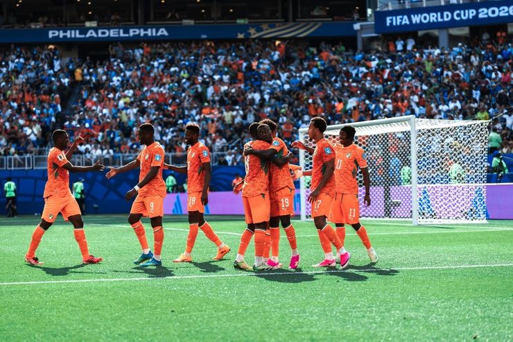 Ivory Coast players celebrate in a huddle after scoring against Curaçao at Philadelphia Stadium
