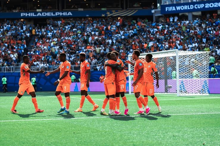 Ivory Coast players celebrate in a huddle after scoring against Curaçao at Philadelphia Stadium