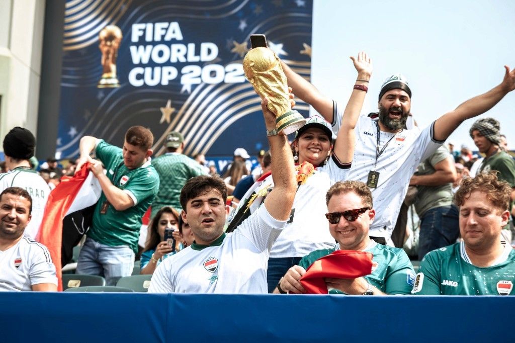 Iraq fans hoist a replica World Cup trophy in the stands during France vs Iraq at World Cup 2026