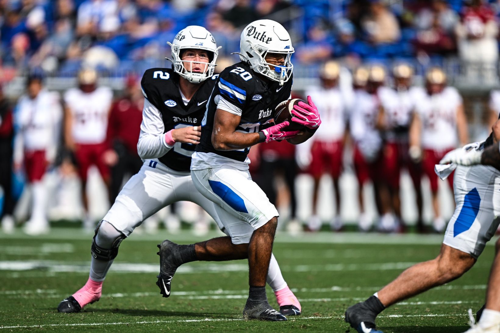 Duke quarterback Walker Eget (2) hands off to running back Nate Sheppard (20) as Boston College players look on from the sideline during Duke's 47-2 win at Wallace Wade Stadium on Oct. 31, 2026.