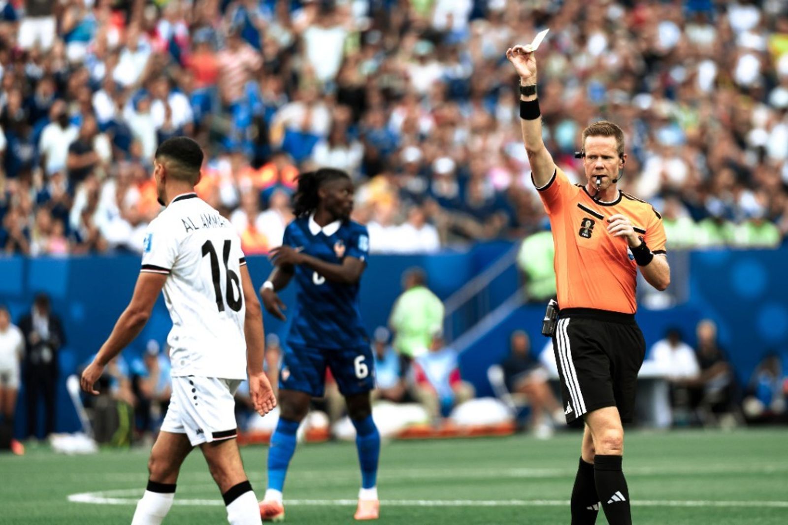 The referee shows a yellow card to Iraq's Al-Ammari during France vs Iraq at World Cup 2026