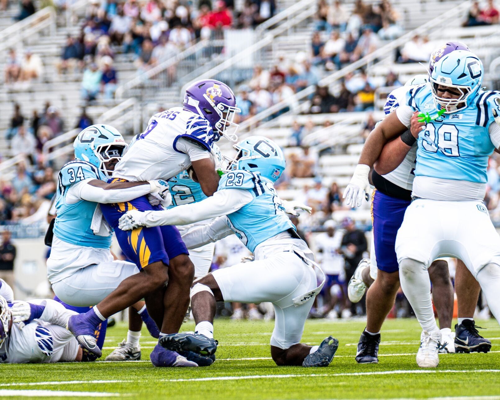 The Citadel's JJ Fludd (23) and Jalen Wright tackle Tennessee Tech running back MJ Flowers at Johnson Hagood Stadium during Tennessee Tech's 28-13 win on Oct. 24, 2026