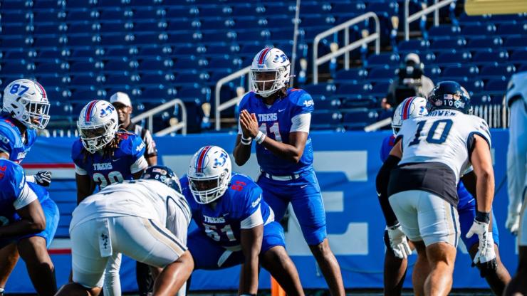 Tennessee State quarterback No. 11 under center as Charleston Southern defenders in white line up across from the Tigers at Nissan Stadium, Oct. 24, 2026