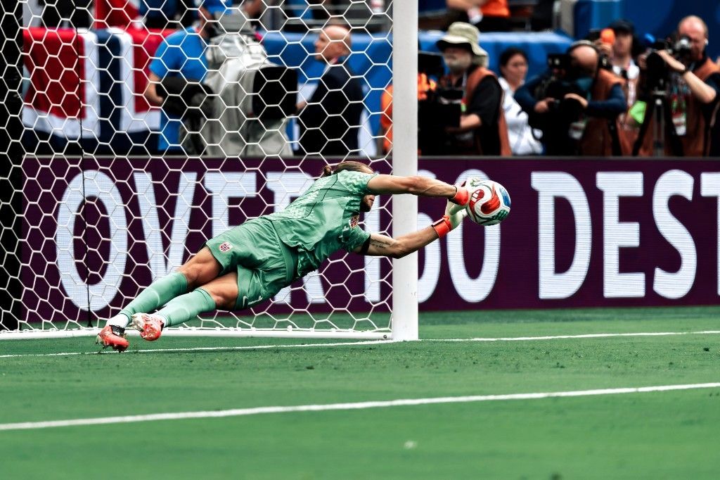 Norway goalkeeper Orjan Nyland dives to catch the ball during a spectacular save against Brazil