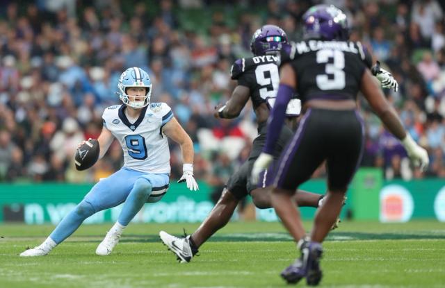 UNC quarterback Billy Edwards Jr. scrambles against TCU at Aviva Stadium in Dublin
