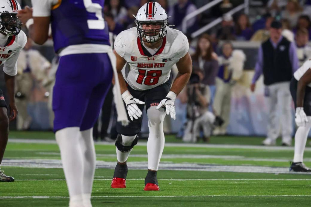 Austin Peay defender No. 18 in a white road jersey sets in a stance across from a North Alabama player in purple during the Govs' 27-21 win at Bank Independent Stadium on Oct. 24, 2026