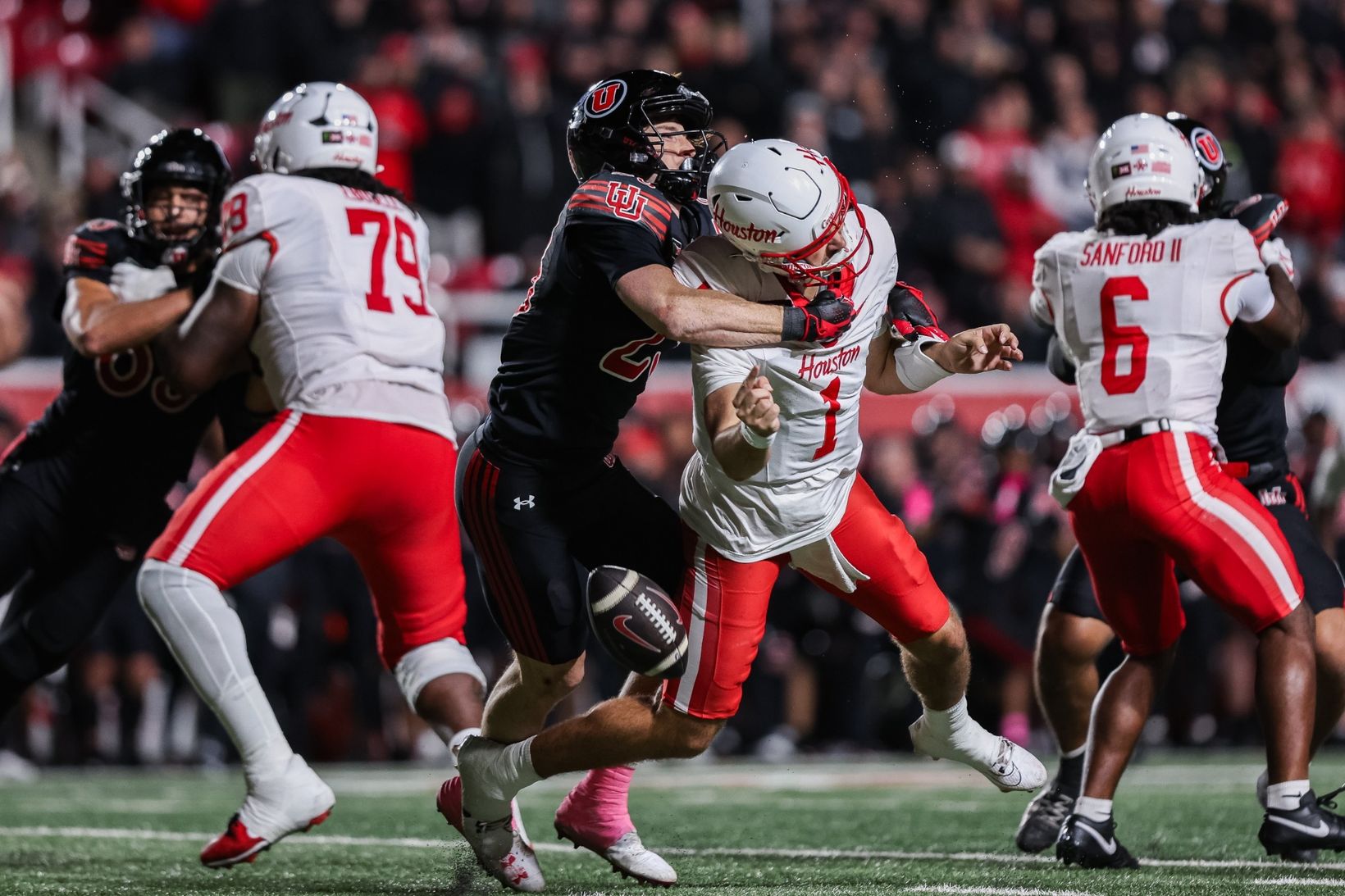 Utah's Jackson Bennee, in a black jersey, hits Houston quarterback Conner Weigman and knocks the ball loose at Rice-Eccles Stadium during Utah's 21-13 win on Oct. 24, 2026.