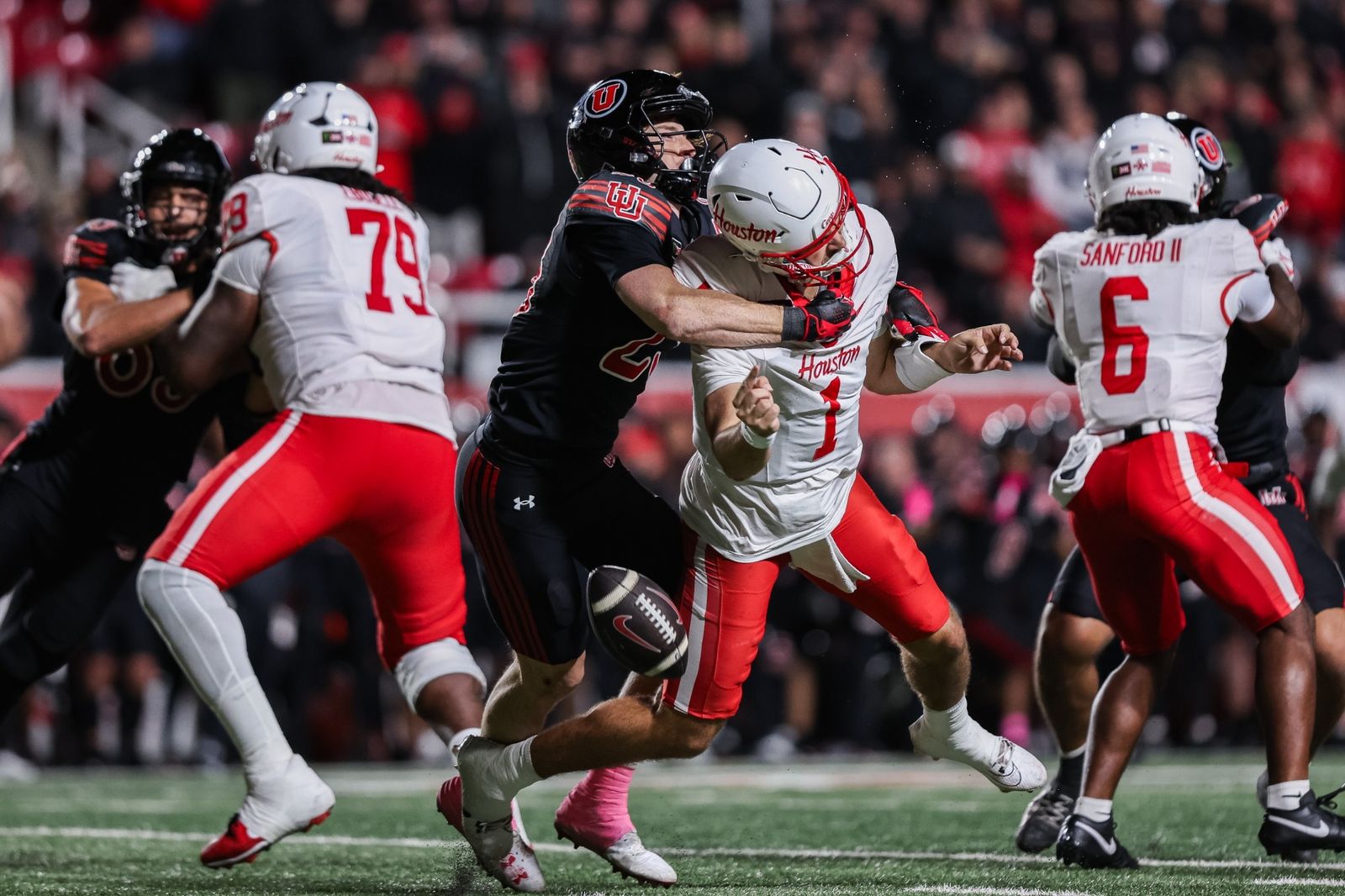 Utah's Jackson Bennee, in a black jersey, hits Houston quarterback Conner Weigman and knocks the ball loose at Rice-Eccles Stadium during Utah's 21-13 win on Oct. 24, 2026.