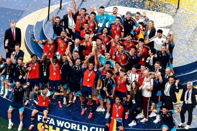 Spain players lift the FIFA World Cup trophy on the champions podium after beating Argentina in the 2026 final