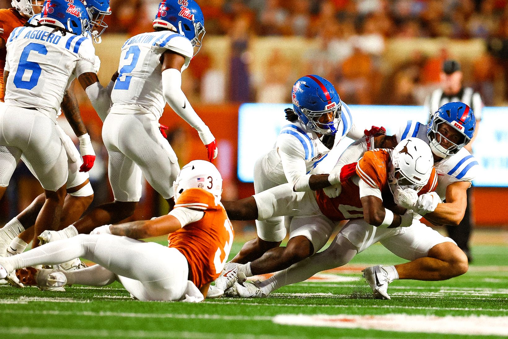 Ole Miss defenders bring down a Texas ball carrier during No. 19 Texas' 34-27 win over No. 7 Ole Miss at DKR-Texas Memorial Stadium on October 24, 2026.