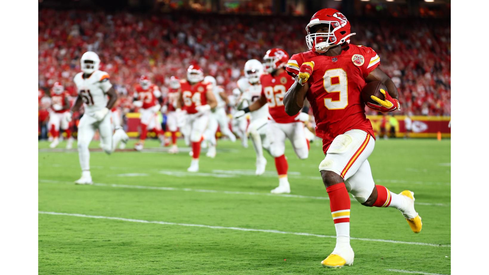 Kansas City Chiefs running back Kenneth Walker III (9) runs into open field ahead of trailing Denver Broncos defenders at Arrowhead Stadium