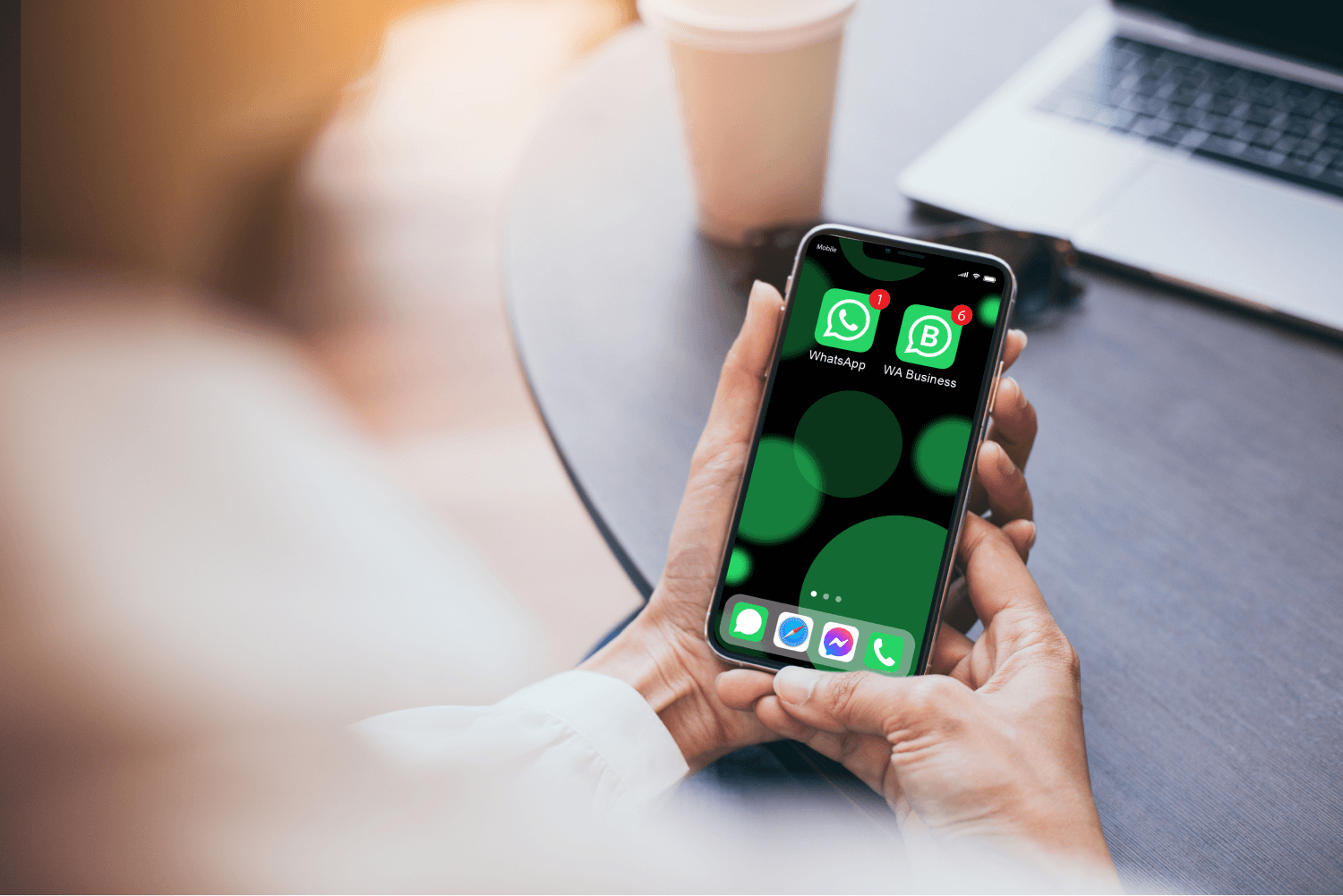 office worker hands holding a phone with WhatsApp and WhatsApp Business installed on it