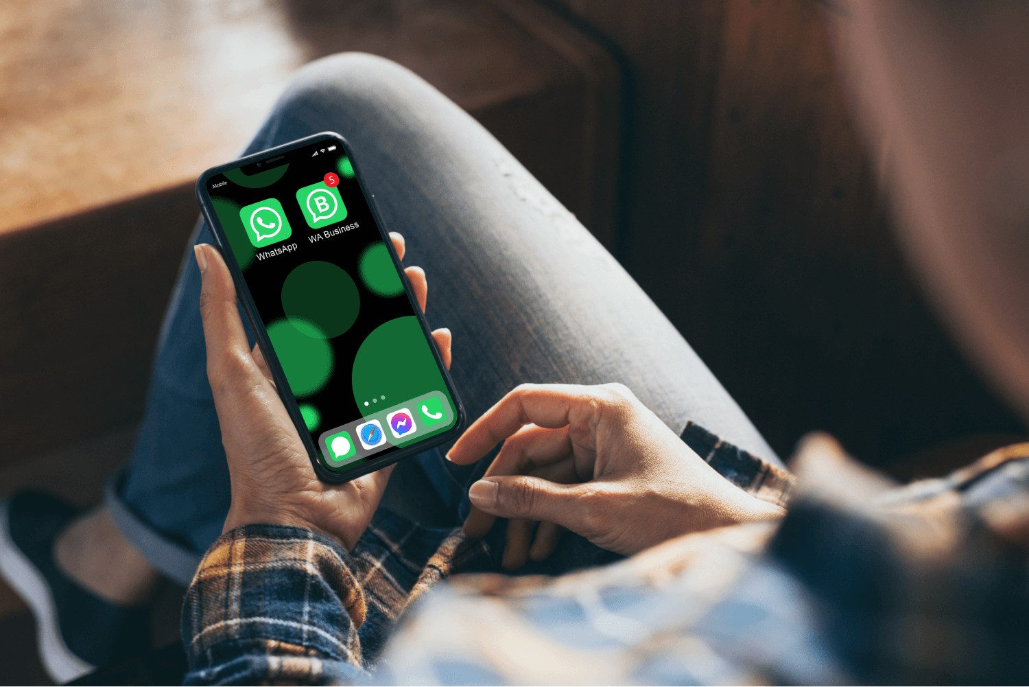 hands holding a phone with WhatsApp and WhatsApp Business installed on it