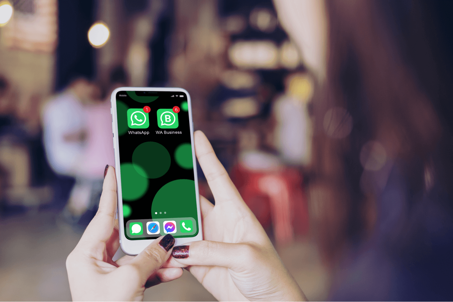 hands holding a phone with WhatsApp and WhatsApp Business installed on it