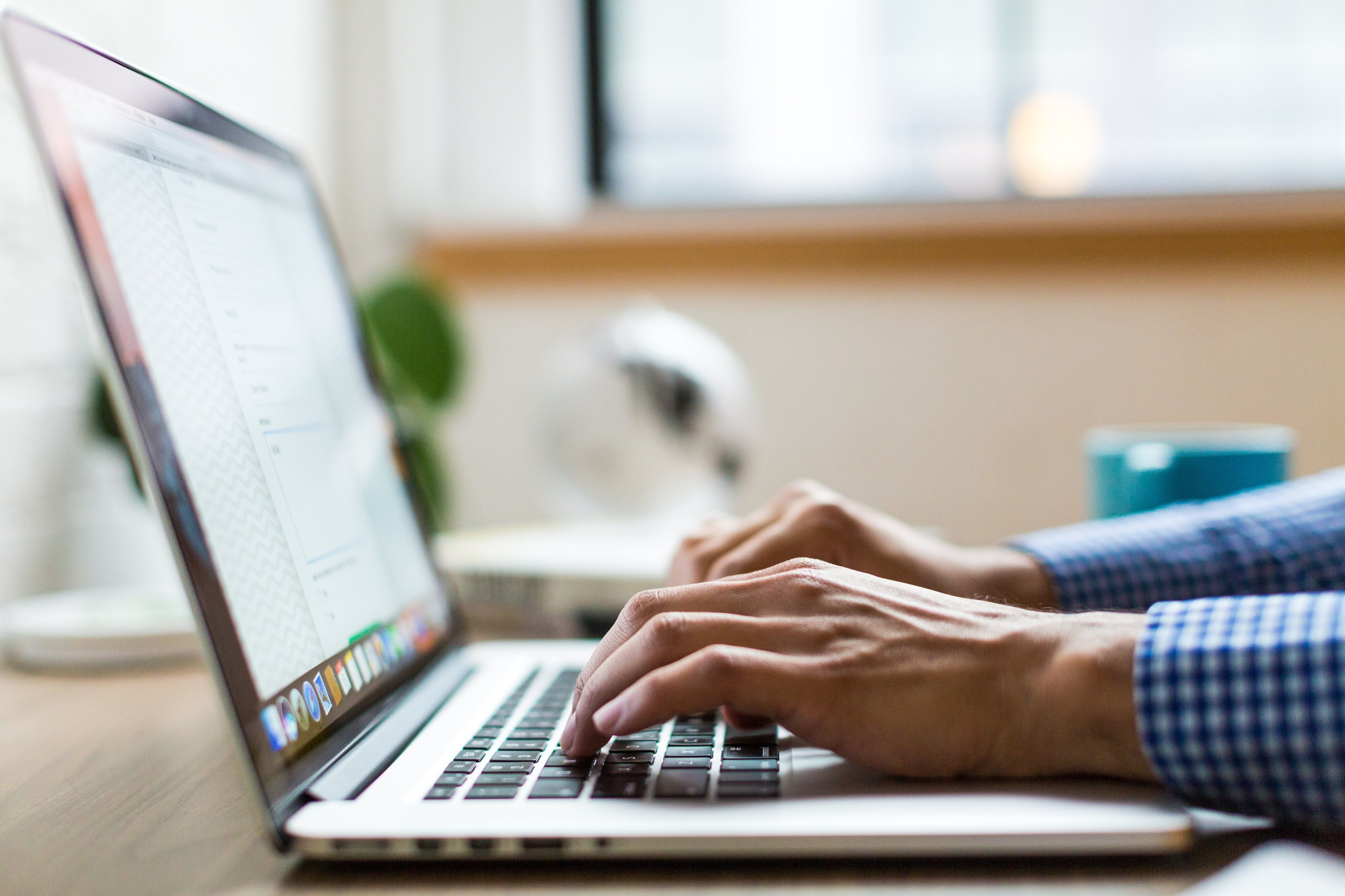Male hands typing on a keyboard