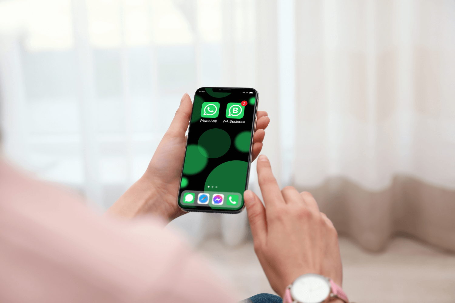 office worker hands holding a phone with WhatsApp and WhatsApp Business installed on it