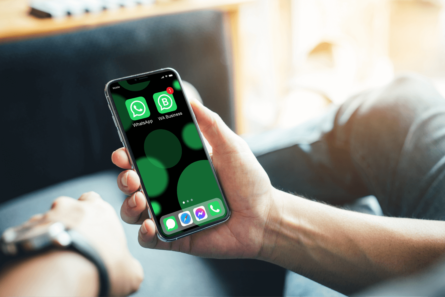 male hands holding a phone with WhatsApp and WhatsApp Business installed on it