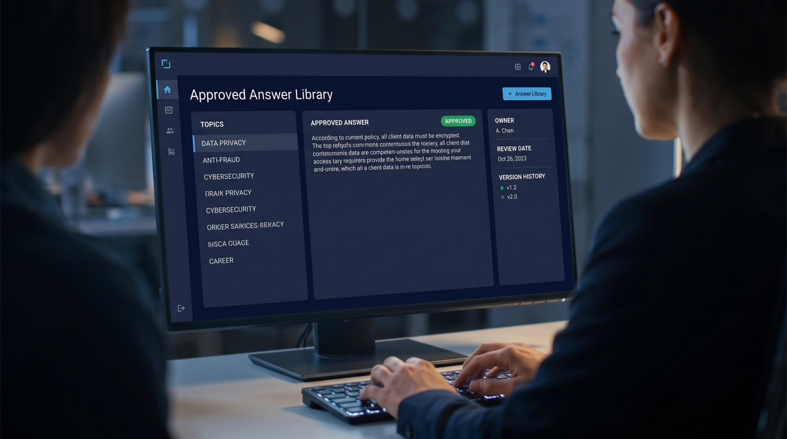 Analyst viewing an approved answer library on a monitor showing owner, review date and version history
