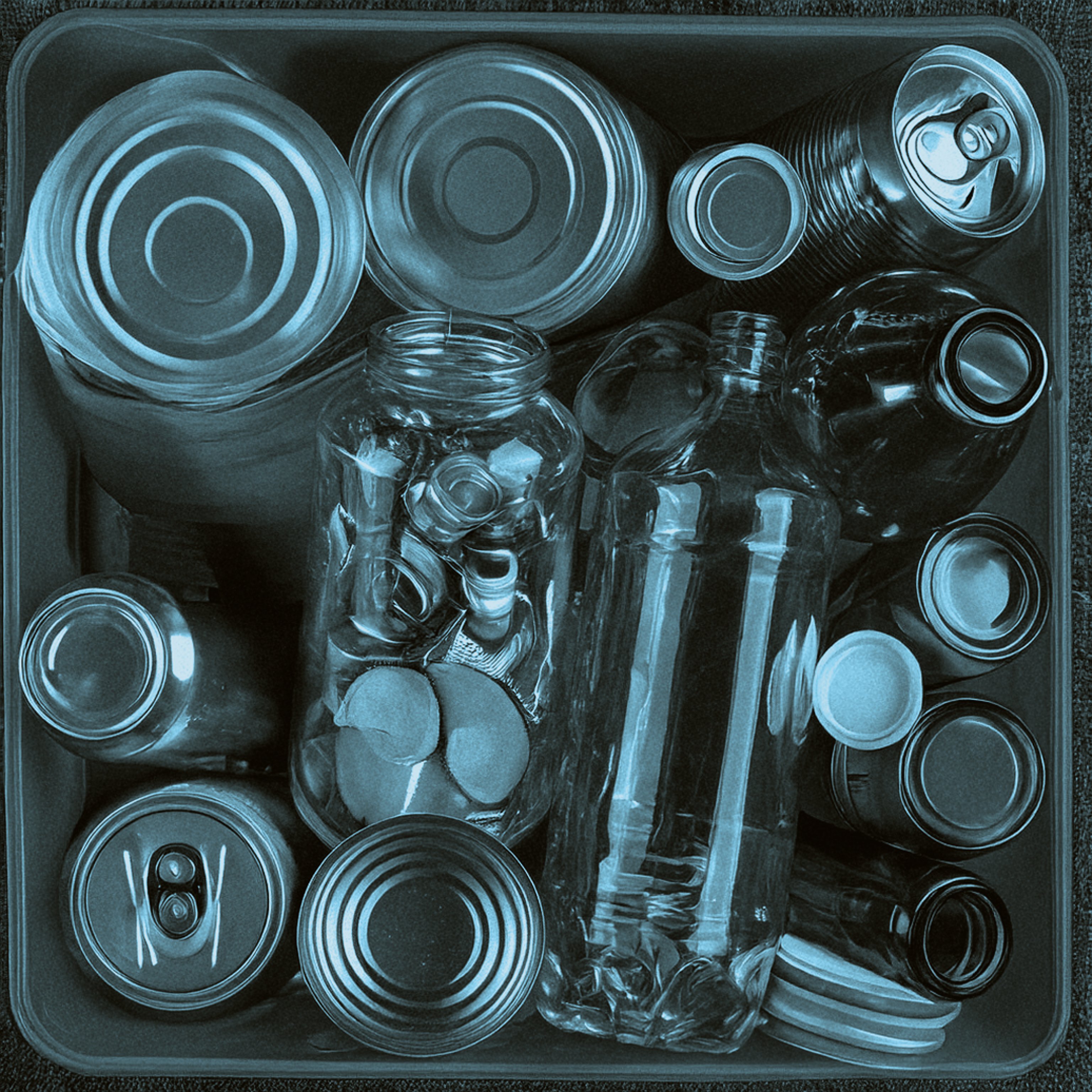 Two glass bottles with a aluminium can in front of them.