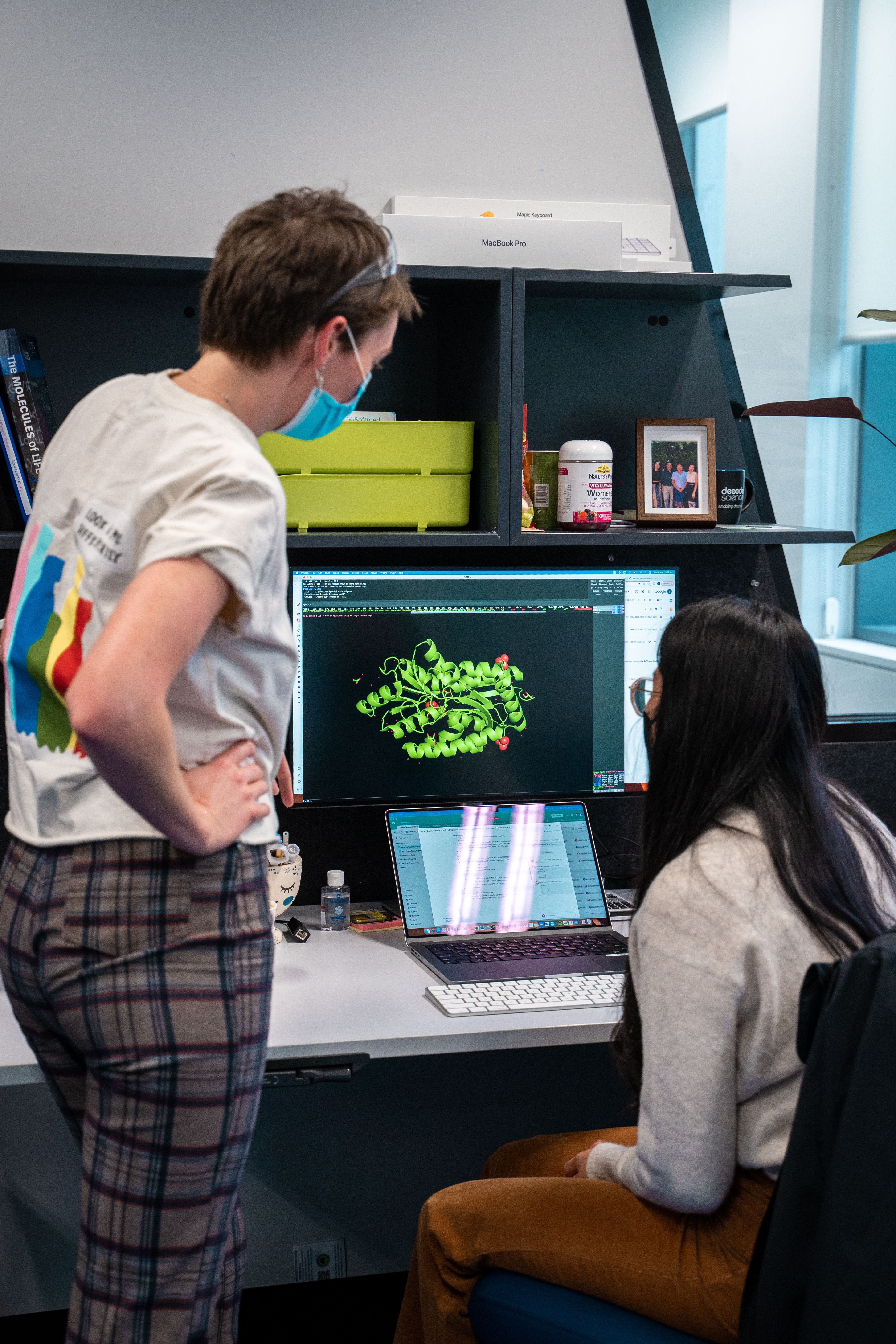 two people looking at a computer screen which a render structure of an enzyme