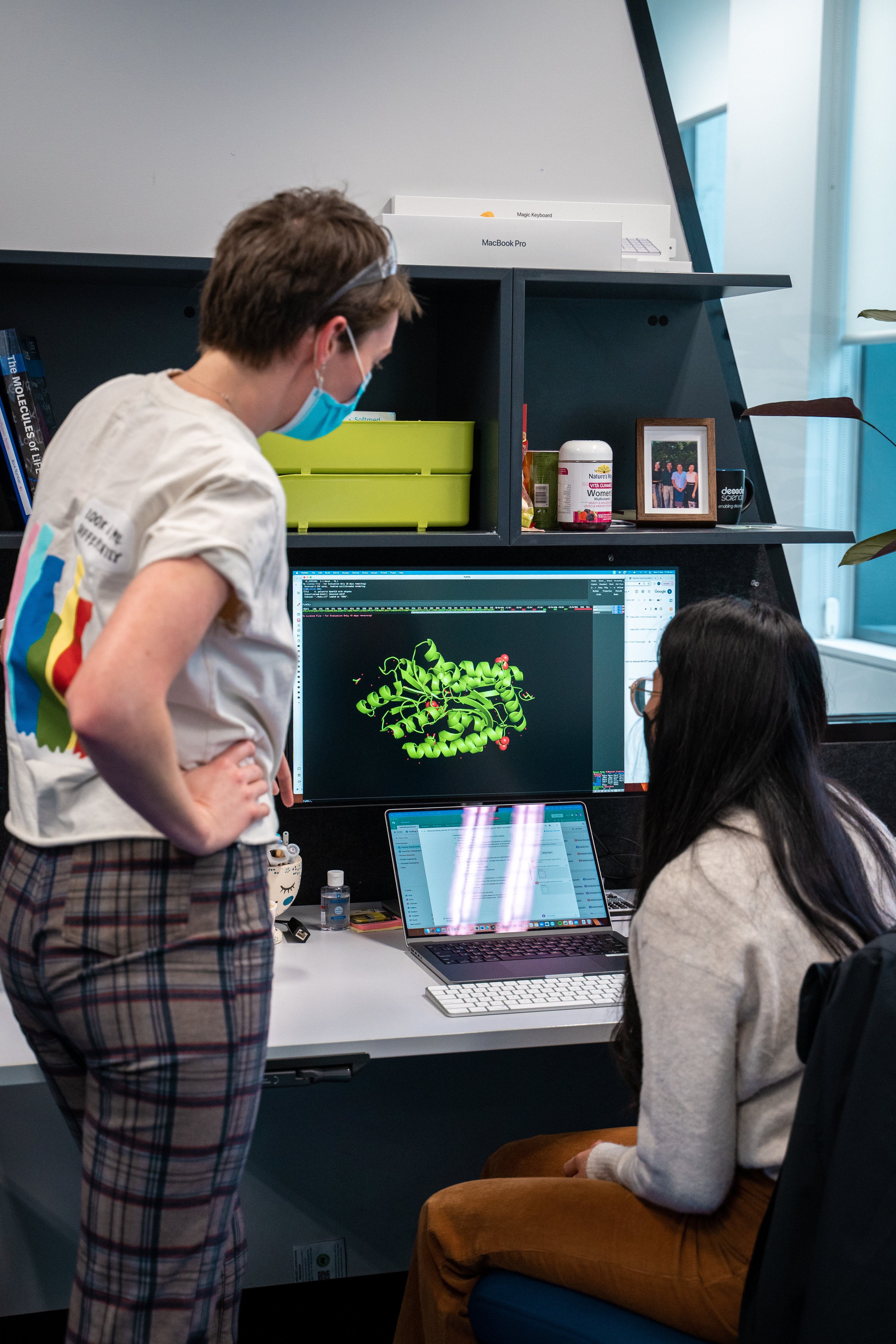 two people looking at a computer screen which a render structure of an enzyme